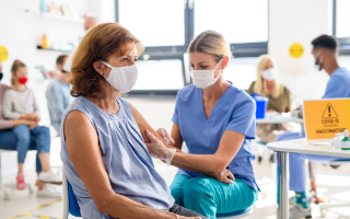 Female nurse injecting a patient